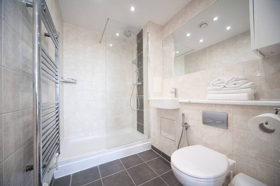 The ensuite bathroom has a shower and a bidet shower, providing added comfort and convenience. It is fully stocked with all the necessary toiletries.