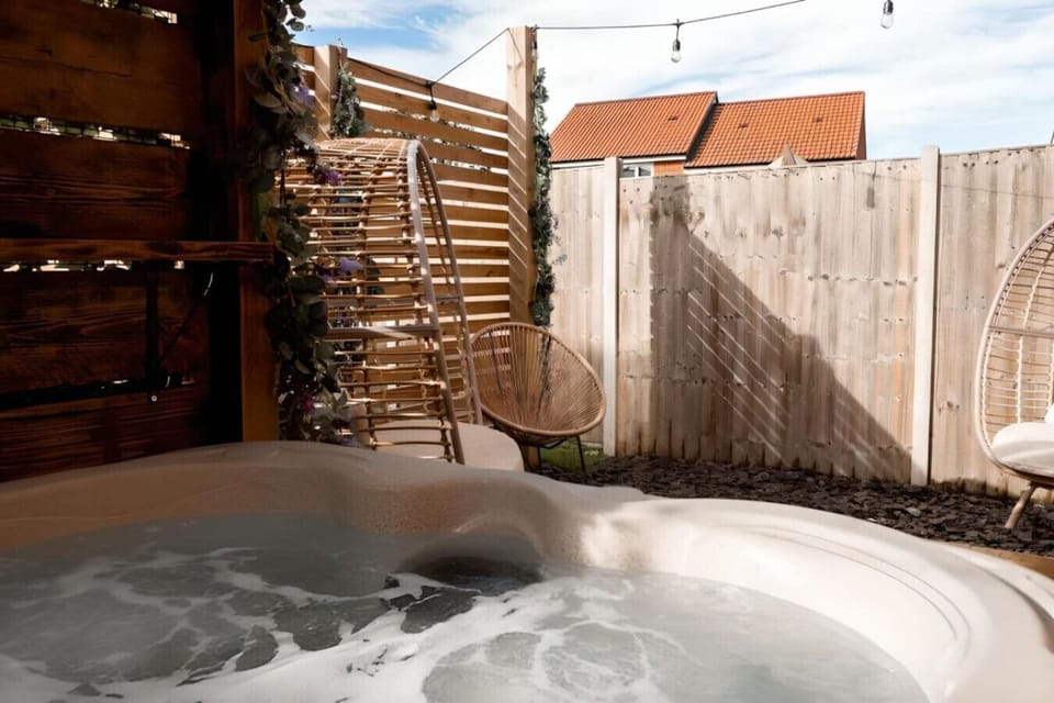 Soak up relaxation in a private hot tub, enveloped by rustic wood paneling and soft, ambient lighting.Soak up relaxation in a private hot tub, enveloped by rustic wood paneling and soft, ambient lighting.