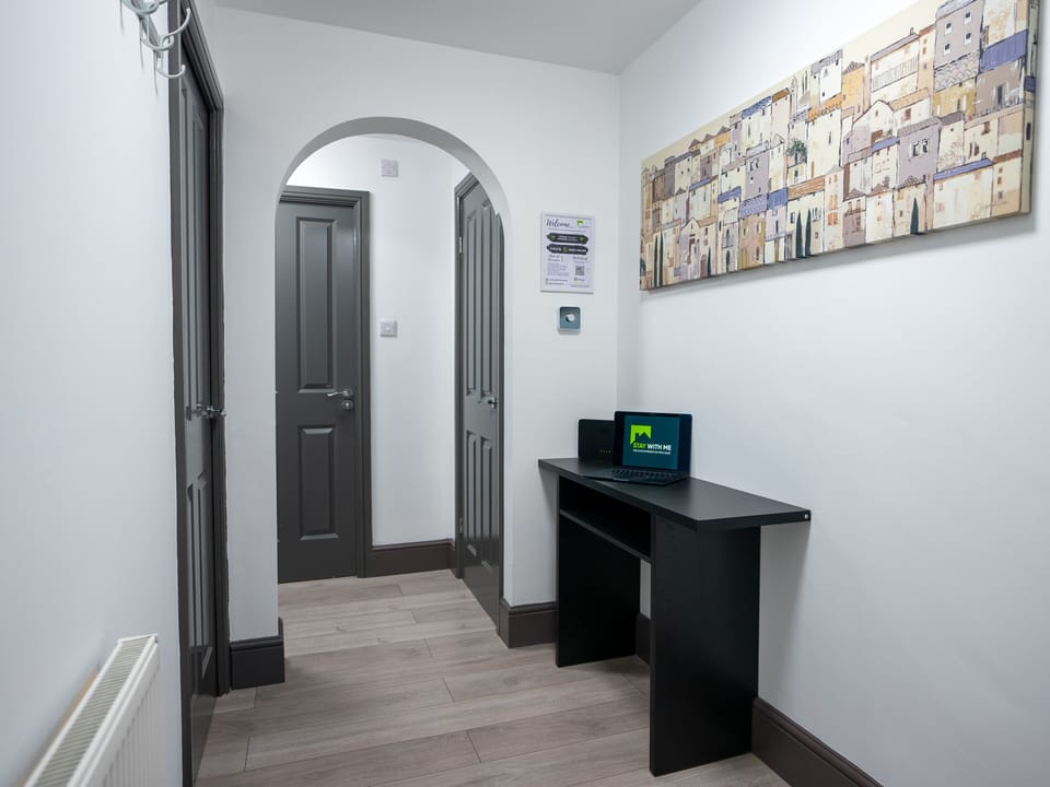 The walkway in this area serves a dual purpose, not only providing a passage between spaces but also incorporating an additional workspace.