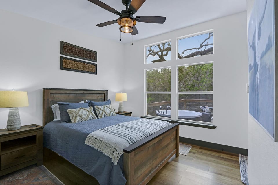 View of the queen bed from the entrance to the bathroom.