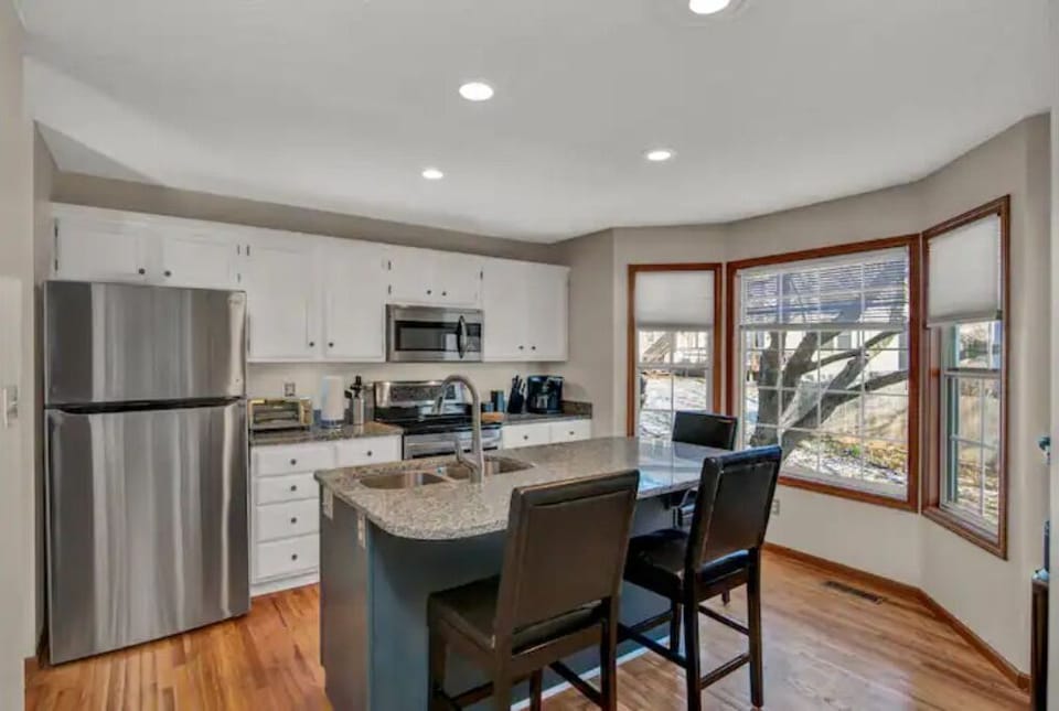 Kitchen with granite counter tops and ground and pod coffee maker and coffee.