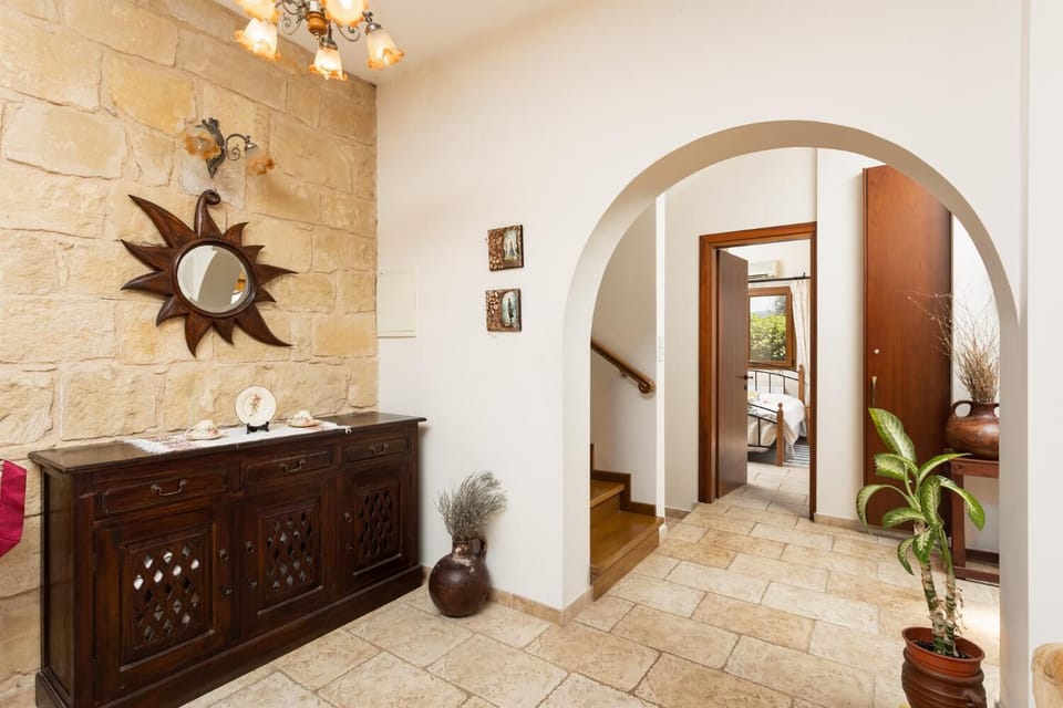 Open-plan living room on ground floor with sofas, dining area, kitchen, ornamental fireplace, A/C, WiFi internet, satellite TV, and sea views