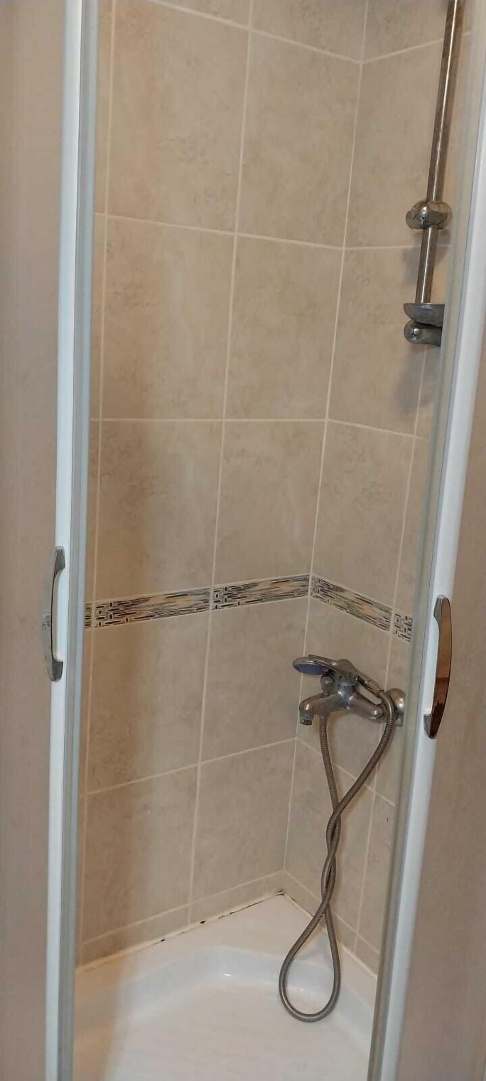 Shower, hair dryer, slippers, towels