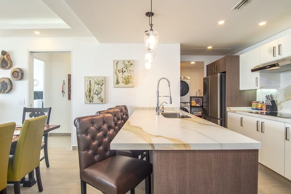 long countertop with leather seating defines the kitchen