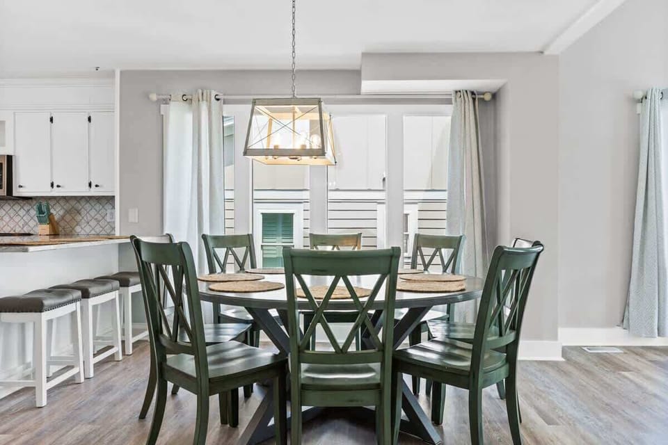 Gather around the stylish table and enjoy meals with a view of the ocean breeze!