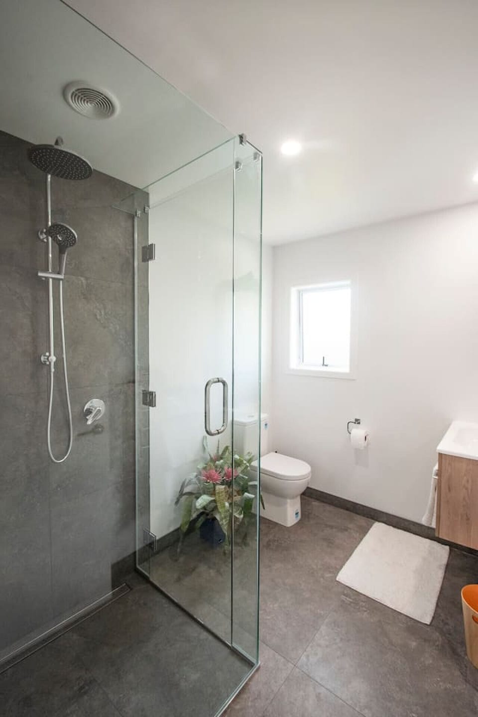 Clean, modern bathroom with fully tiled shower