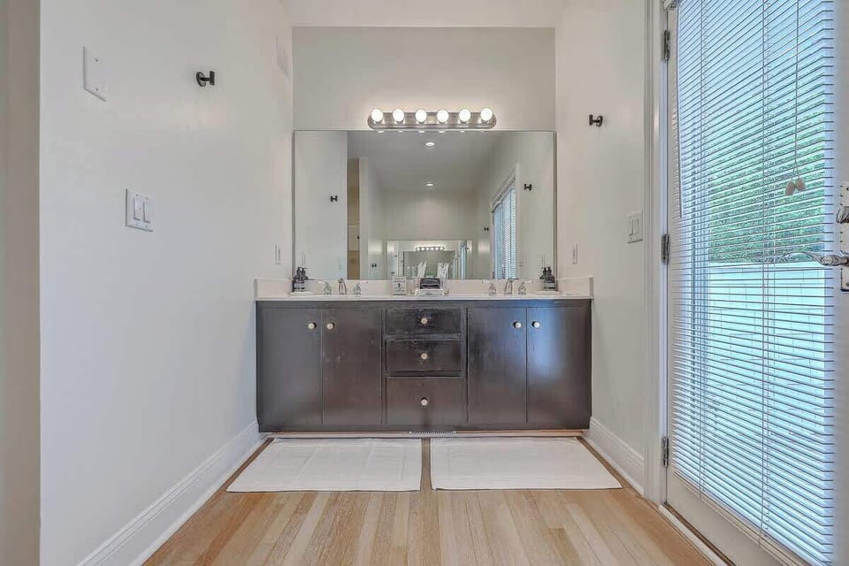 Spacious master bathroom featuring a private balcony, perfect for morning coffee and quiet moments.