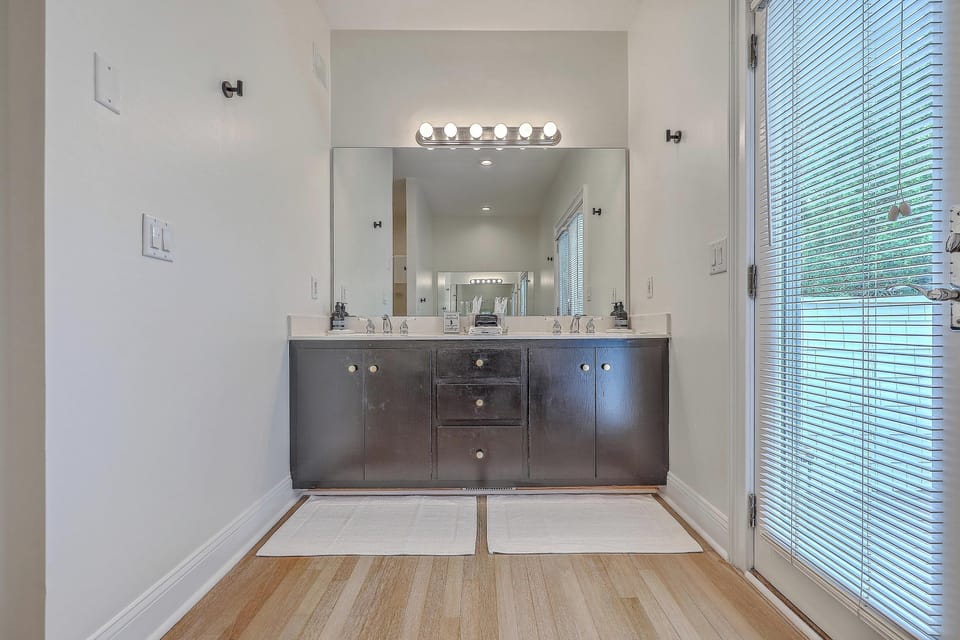 Spacious master bathroom featuring a private balcony, perfect for morning coffee and quiet moments.