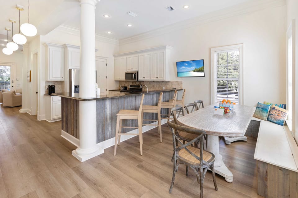 Gather around this spacious dining table where you'll share meals and make memories in your bright, open-concept haven.