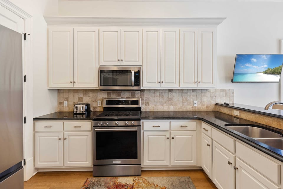 Your fully equipped kitchen awaits with modern appliances and ample counter space for preparing memorable vacation meals together.