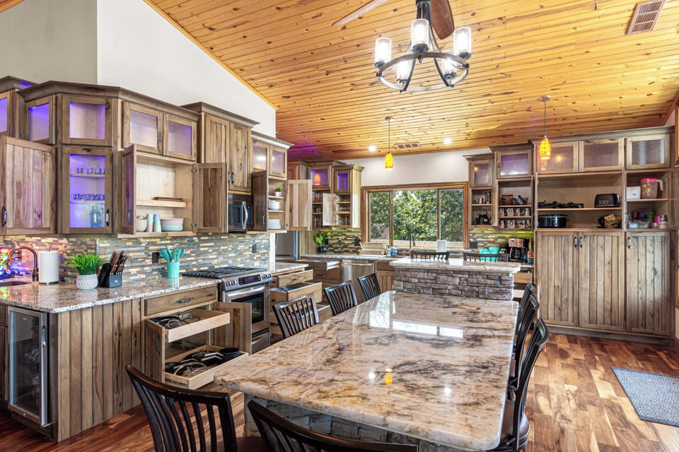 The kitchen comes fully stocked and ready to entertain, with 2 full-sized refrigerators, 2 indoor mini fridges, and 2 more on the dock for easy access to cold drinks by the lake