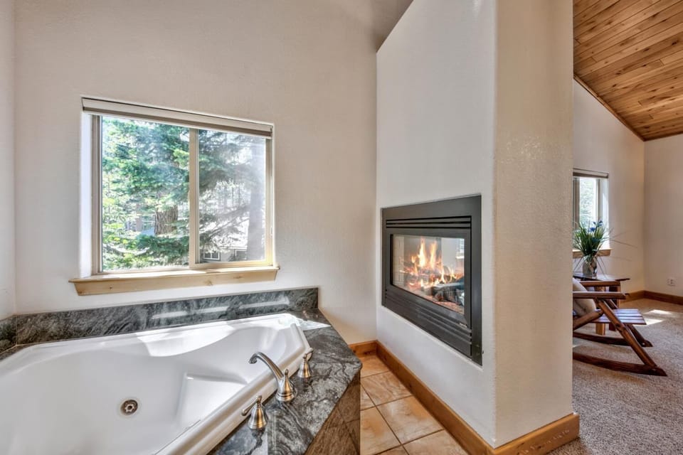 Primary en-suite bathroom with a jetted tub, walk-in shower, gas - Primary en-suite bathroom with a jetted tub, walk-in shower, gas fireplace, and double sink