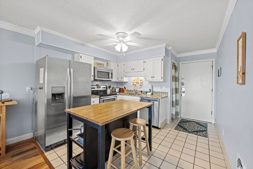 The kitchen island provides additional counter space for serving snacks or meals