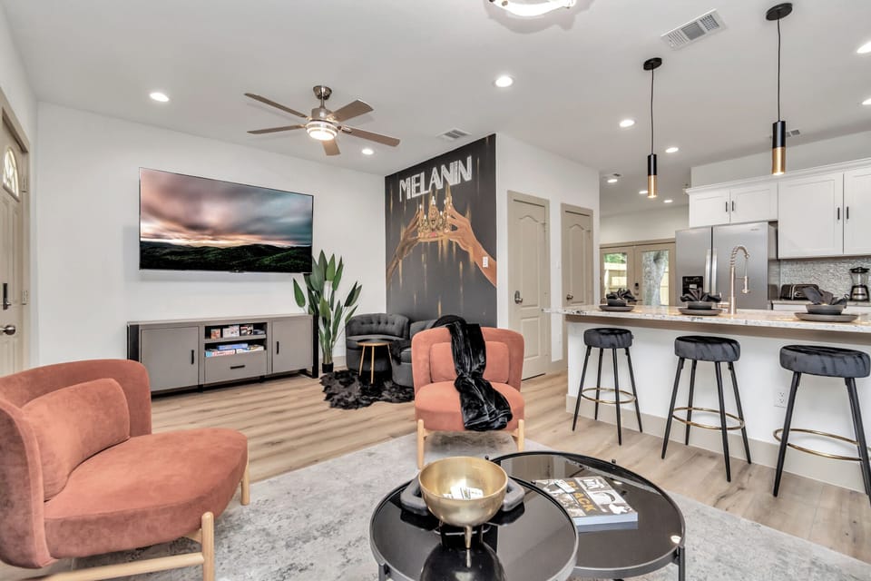 Living Room with 75-inch TV, board games, LED lights, and a perfect photo op at the Melanin wall