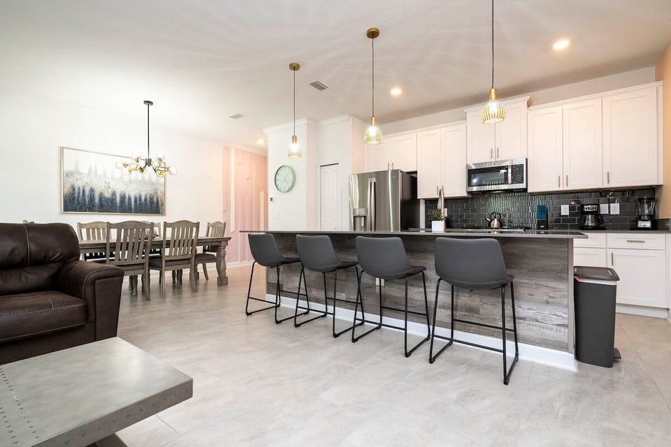 The fully equipped kitchen features modern appliances, sleek cabinetry, and all essential cookware and utensils, making it perfect for preparing meals with ease.