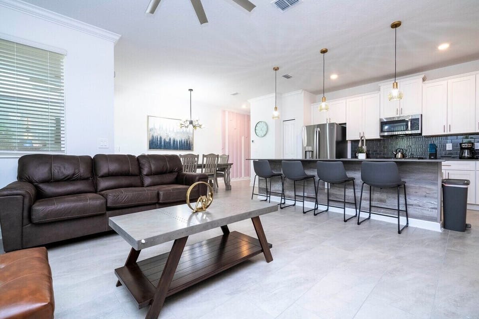 Step into this spacious, comfortable living area. The expansive room is adorned with tasteful decor, offering a blend of modern aesthetics and homey warmth. 