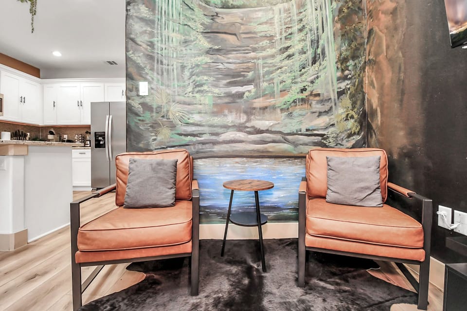 Living Room with Single Couches and a Hand Painted Mural