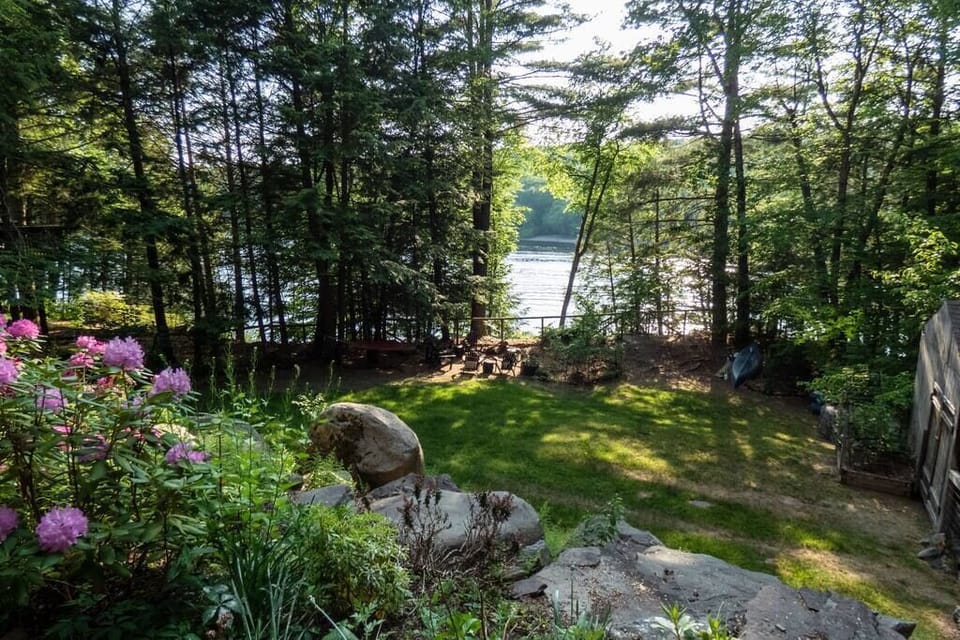Large flat fenced in backyard with views of the lake.