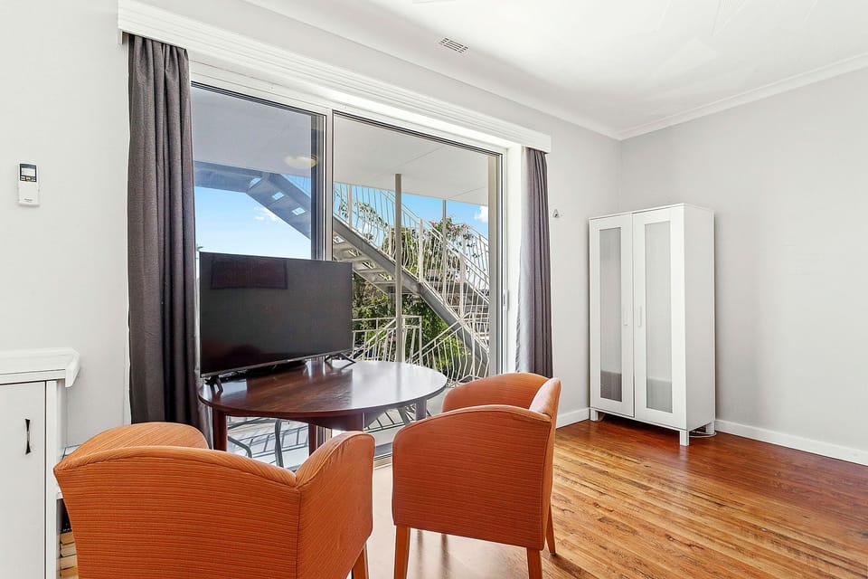 Relax and unwind in this cozy living area, perfect for enjoying the views from the large windows.