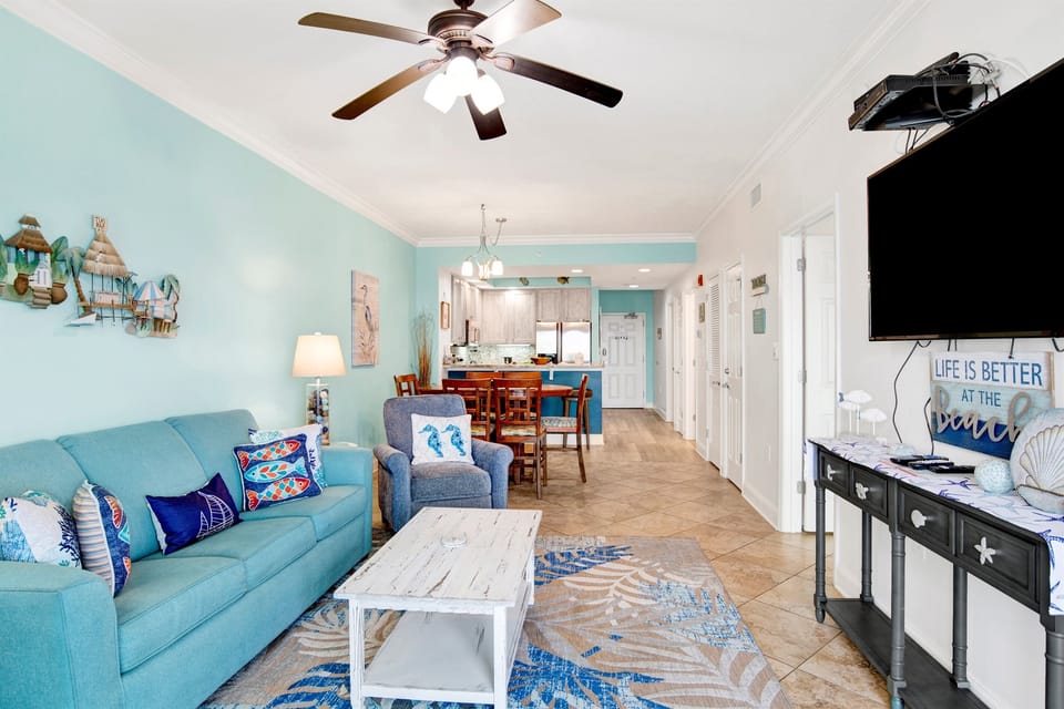 Living room sleeper sofa, 2 end tables, coffee table 2 arm chairs, ceiling fan and a 55" wall mounted Smart TV and a great direct Gulf view