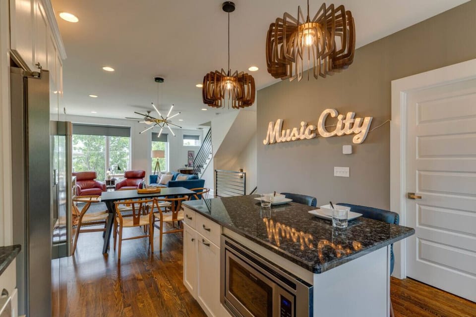 Gather in the kitchen around the island, featuring comfortable seating for two perfect for coffee, meals, or conversation.