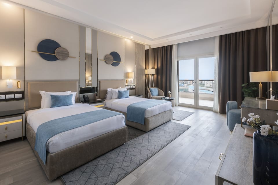 Deluxe Room Sea & Pool View | Minibar, in-room safe, individually decorated, individually furnished