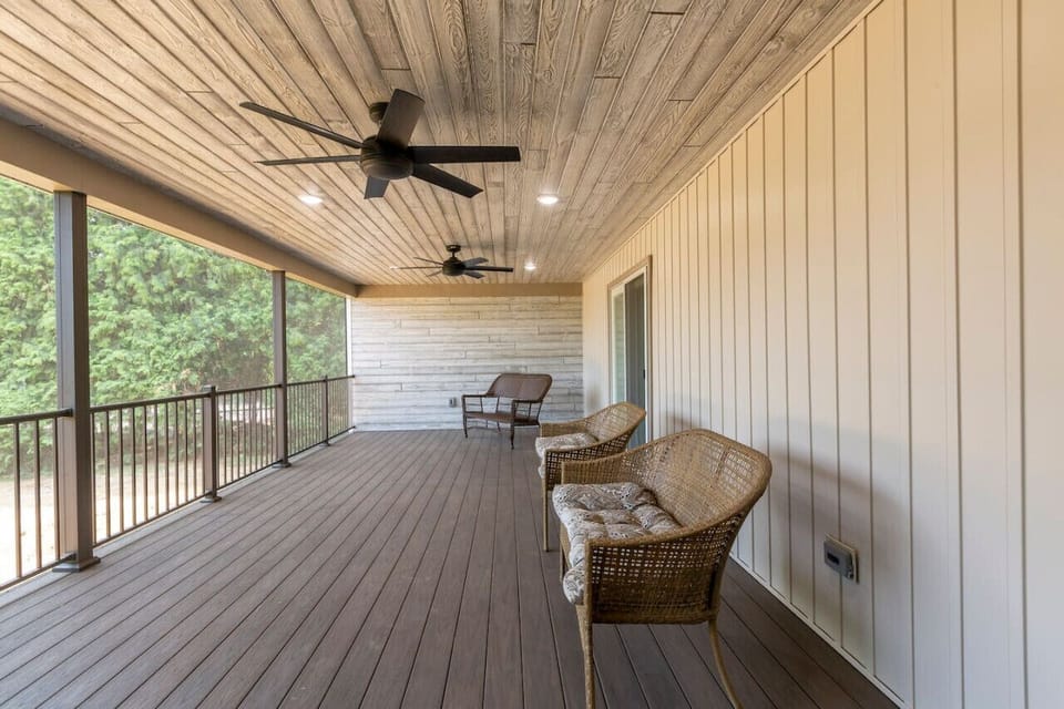 Large screened back porch overlooking a large yard.