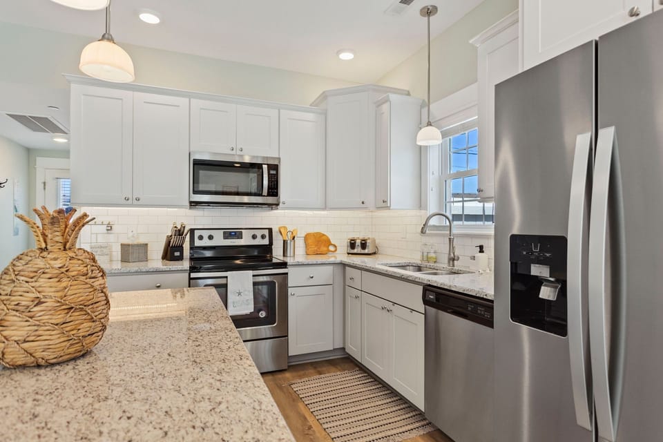 The modern Kitchen with granite countertops and stainless steel Whirpool Gold appliances is perfect for preparing an incredible meal.