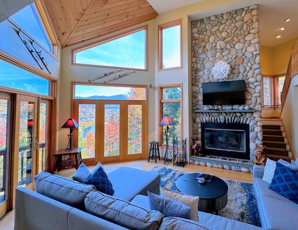 Main Living Room with gorgeous wood Fireplace, cozy seating, and TV