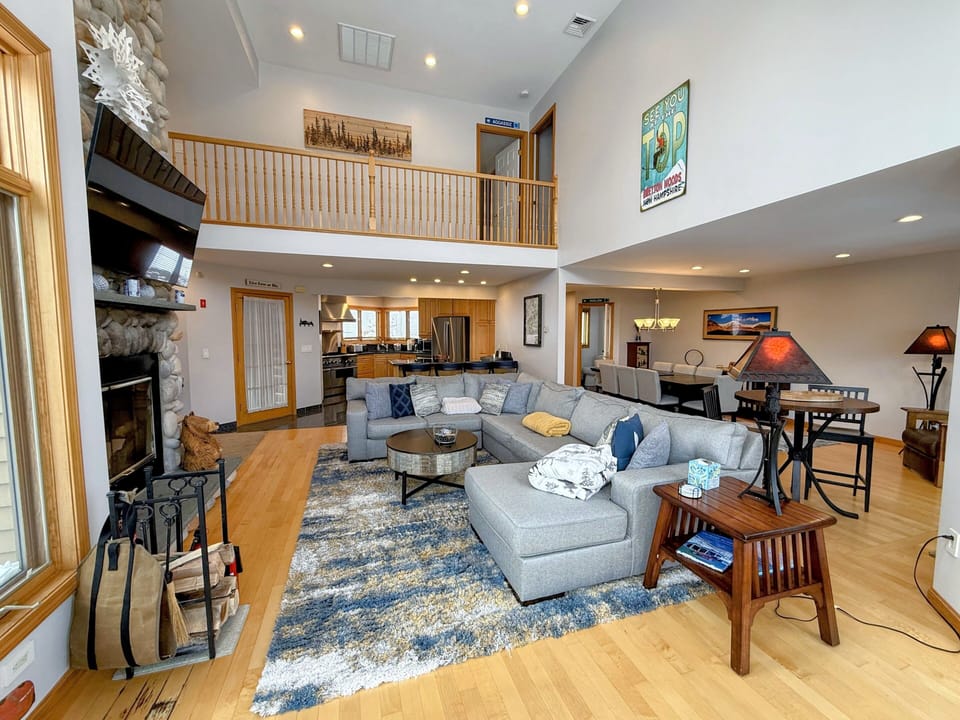 Main Living Room with Wood Fireplace and TV