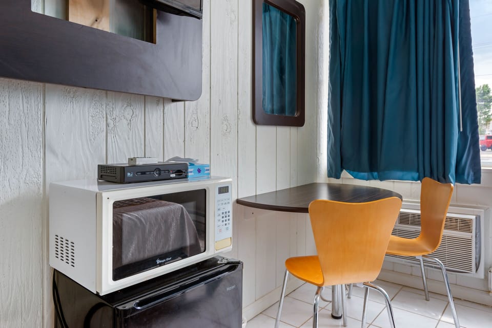 Premium bedding, desk, laptop workspace, blackout drapes