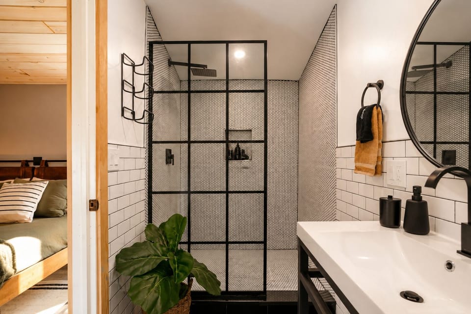 Step into the glass shower and rinse off after a long day, with a shelf inside for your shampoo and soap. Dry off with the towel on the ring hook before heading back to the room.