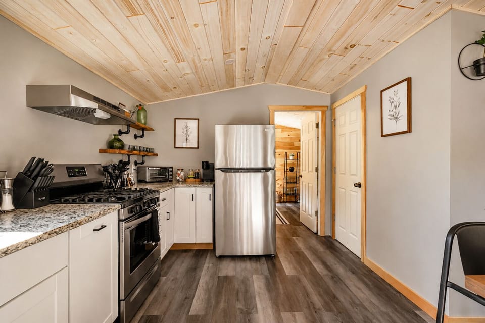 Cook a full meal on the gas range and keep drinks cold in the fridge just steps away. The counter's open enough to prep a big dinner without feeling cramped in the space.
