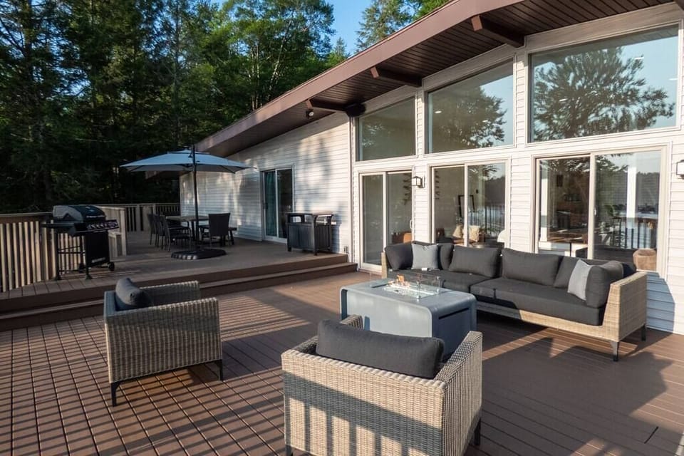 The large deck has an outdoor dining area and a gas fireplace.