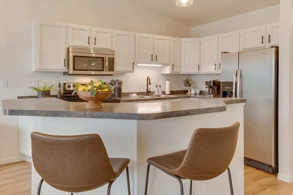 Our versatile kitchen bar, serves as both a dining spot as well as extra seating for guest gatherings.