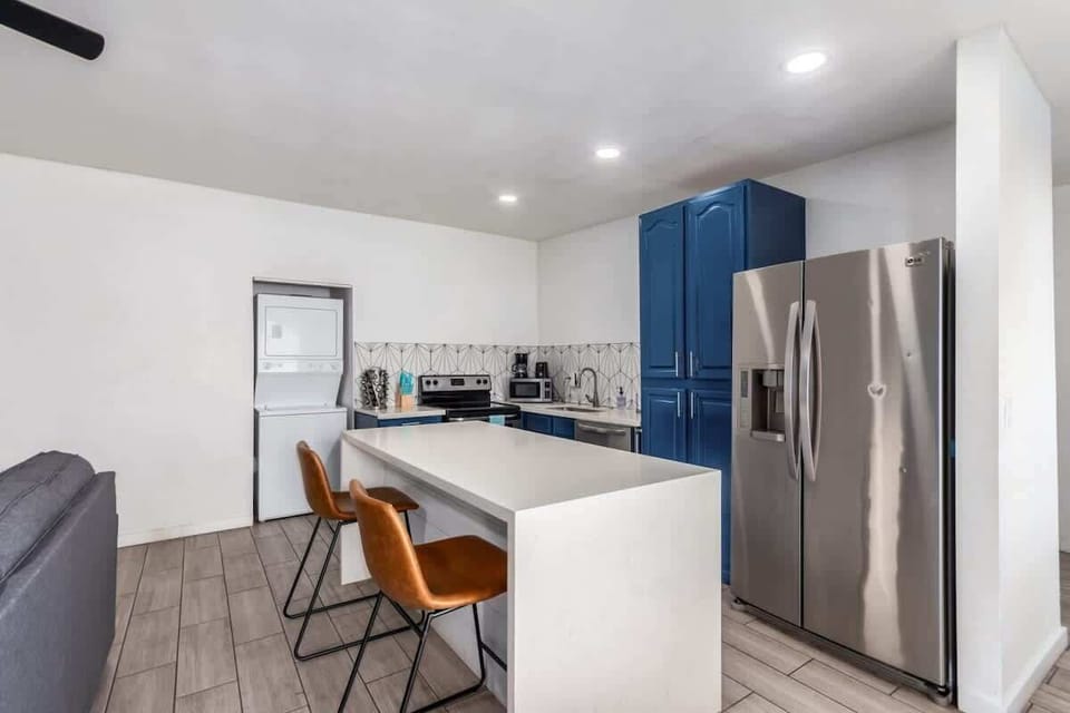 Modern kitchen with a large island, stainless steel appliances, and plenty of seating for group meals.