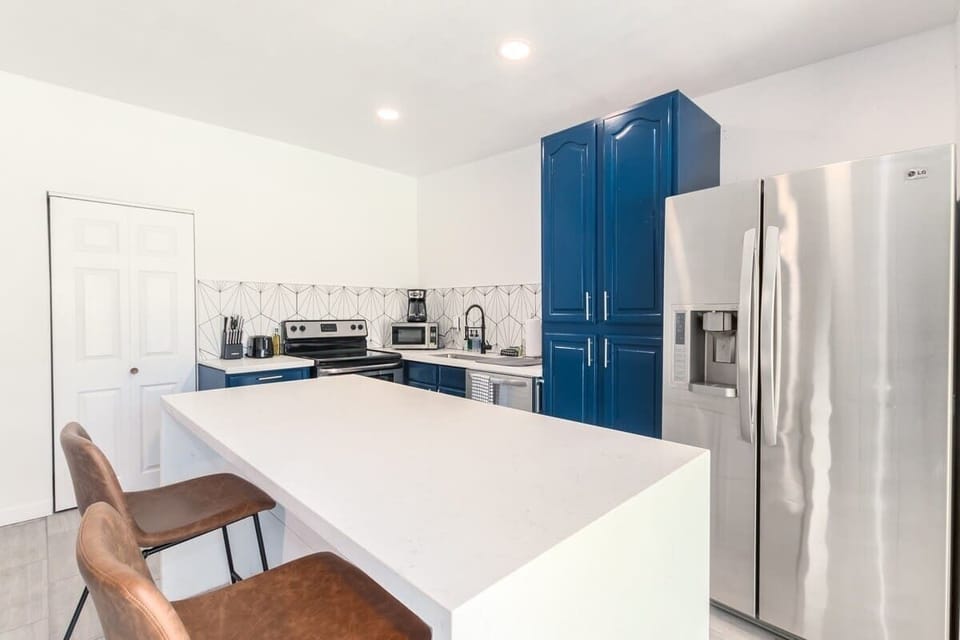 Cook and connect in the modern kitchen, featuring an elegant island and ample seating for family and friends.