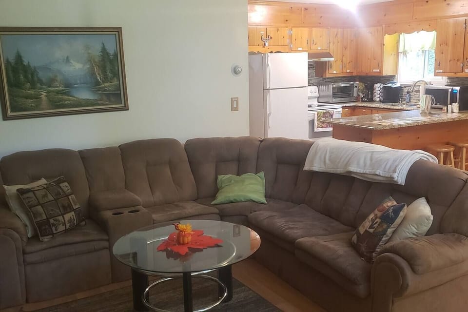 Long wrap around sofa adds a cozy feel while enjoying the fire with friends and family. Couch folds out to a sofa bed. Plenty of extra couch pillows and blankets for comfort.Breakfast bar has bar stools for extra seating in kitchen