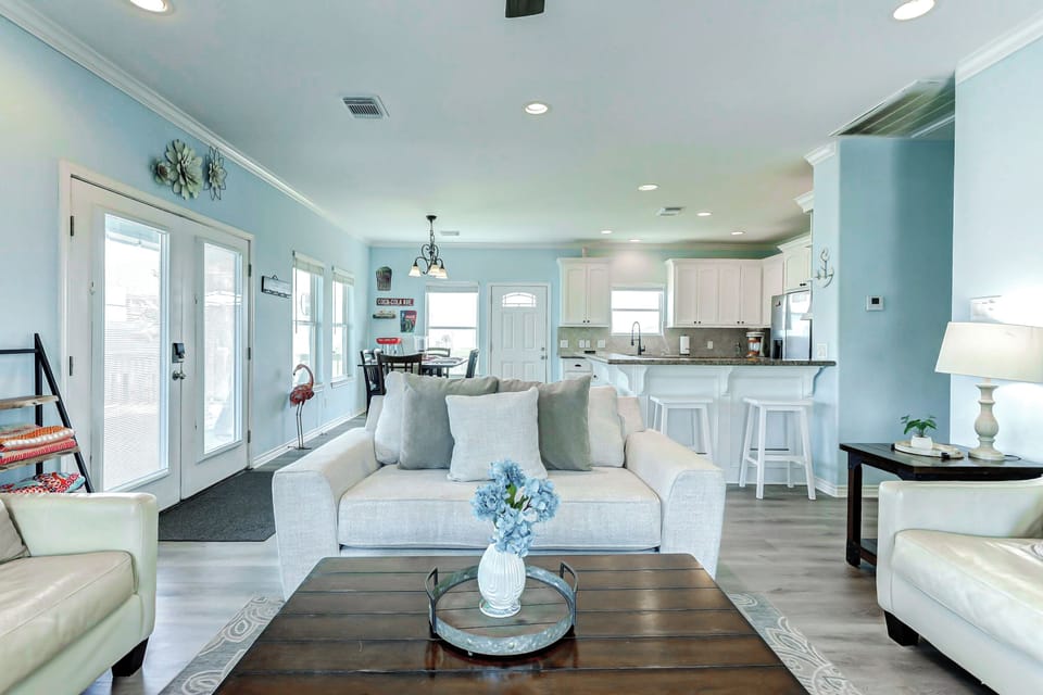 Living Room: Bright and airy space with light decor, perfect for relaxing after beach adventures!