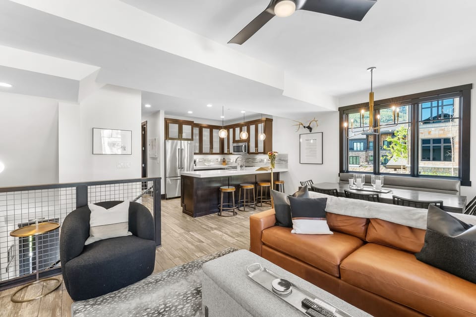 - Gather in an open living space with stylish seating and warm textures  
- Cook in the modern kitchen with island seating and pendant lighting  
- Share meals in a bright dining area with large windows and views