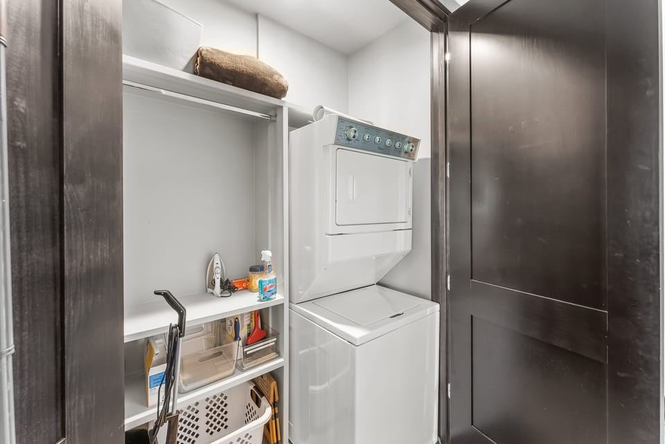 - In-unit laundry with stacked washer and dryer for guest use  
- Shelving and supplies make it convenient to stay fresh  
- Essentials included for longer stays and added comfort