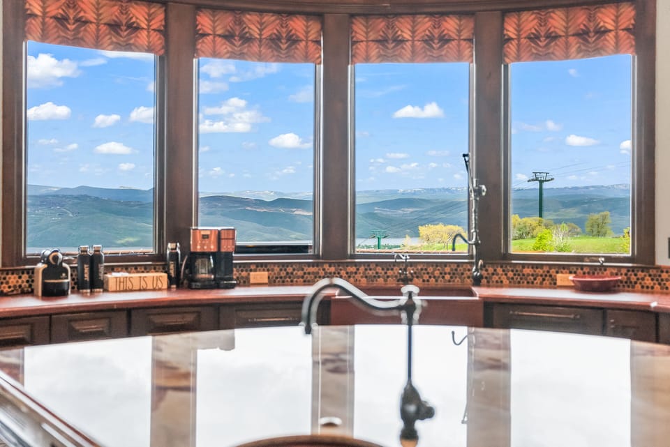 - Kitchen window views of ski lifts and rolling hills  
- Morning coffee station framed by stunning scenery  
- Expansive counter space for cooking and gatherings