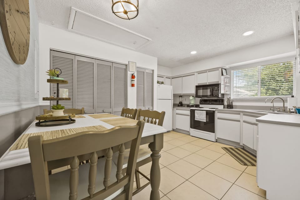 A dining room table for four, and a fully appointed kitchen + laundry room!