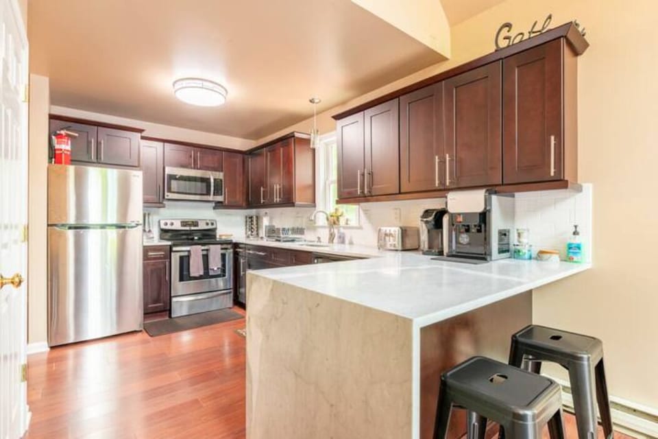 kitchen w/ silverware, pots, pans, bowls, cups, Keurig and hot/cold drinking