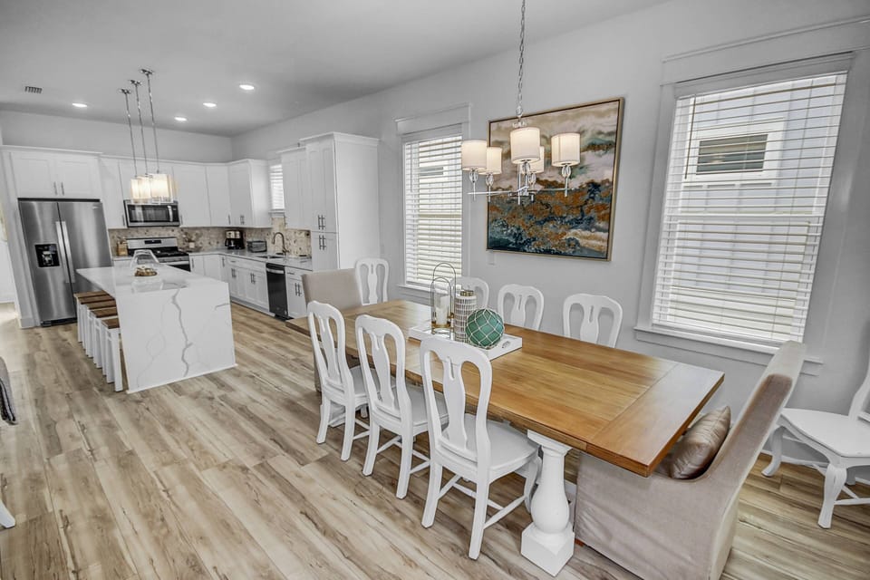 Large farm style dining table with seating for up to 10 guests, and 5 additional seats at the expansive kitchen island!
