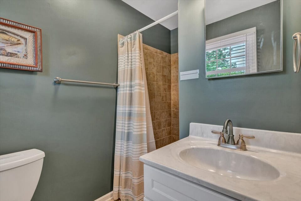 Stylish primary bath en suite offering a private oasis for unwinding.