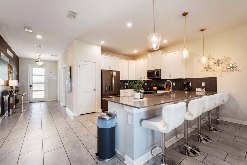 Spacious kitchen with island seating, perfect for entertaining and culinary adventures.