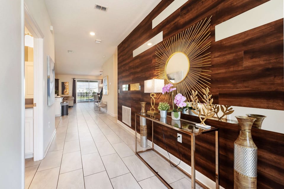 Step into elegance with a sunburst mirror and chic decor, welcoming you to a luxurious stay.
