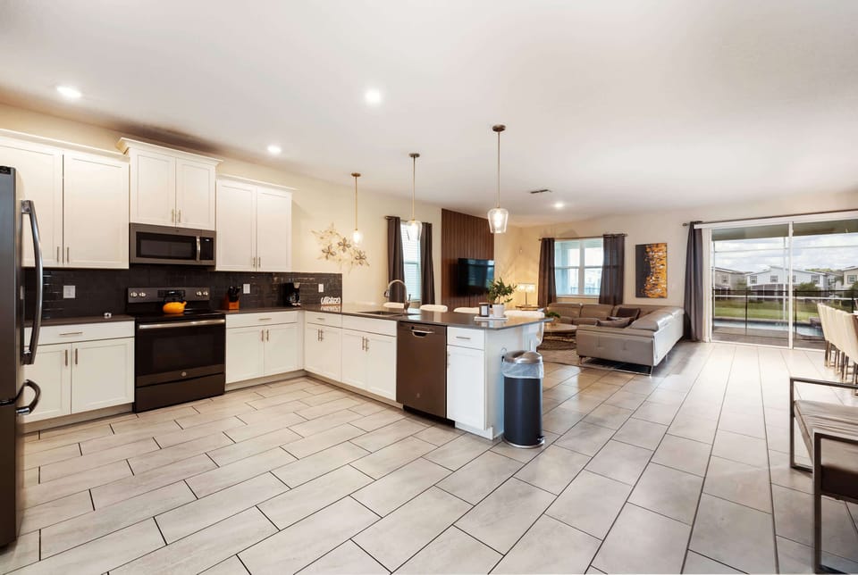 Spacious modern kitchen and living area with sleek design, perfect for entertaining and relaxation.