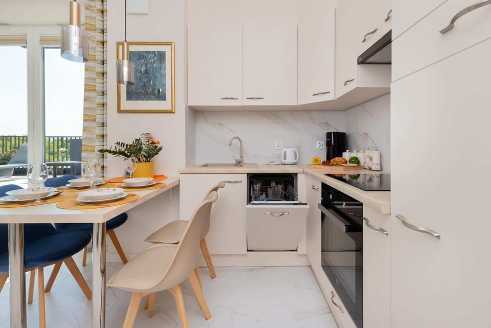Bright kitchen with cooking utensils. 